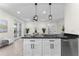Bright kitchen featuring granite countertops and modern appliances at 2503 Dumont Ln, North Port, FL 34286