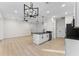 Kitchen featuring a kitchen island with black countertop, stainless steel appliances, and luxury vinyl flooring at 2503 Dumont Ln, North Port, FL 34286