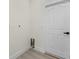 Neutral toned laundry area with white trim, a white door, and electrical and water hookups at 2503 Dumont Ln, North Port, FL 34286