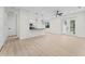Bright, open living space featuring luxury vinyl floors, fan, and modern fixtures adjacent to the kitchen at 2503 Dumont Ln, North Port, FL 34286