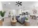 Bright living room featuring modern furnishings, stylish decor, and an open floor plan leading to the kitchen and dining area at 2503 Dumont Ln, North Port, FL 34286