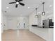 Open-concept area with kitchen island, dining area, and front entry view at 2503 Dumont Ln, North Port, FL 34286