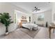Spacious main bedroom featuring light walls, ceiling fan, and several windows at 2503 Dumont Ln, North Port, FL 34286