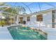 Inviting pool with screen enclosure, seamlessly blending indoor and outdoor living for year-round enjoyment at 2503 Dumont Ln, North Port, FL 34286