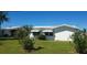 A white single-story home with awnings over the windows and a well-manicured lawn at 3708 97Th N Ave # 3, Pinellas Park, FL 33782