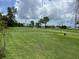 Scenic view of the lush green golf course with mature trees and clear blue skies at 3708 97Th N Ave # 3, Pinellas Park, FL 33782