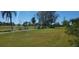 Scenic golf course view with golf carts on a sunny day near tropical foliage at 3708 97Th N Ave # 3, Pinellas Park, FL 33782