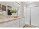 Well-lit bathroom featuring a double vanity and a glass-enclosed walk-in shower at 6022 Jensen View Ave, Apollo Beach, FL 33572