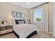 Comfortable bedroom with a neutral color scheme and a large window at 6022 Jensen View Ave, Apollo Beach, FL 33572