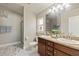 Bathroom featuring a double vanity, granite countertops, and a walk-in shower at 2723 Jollivette Rd, North Port, FL 34288