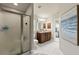 Modern bathroom featuring a glass-enclosed shower, double sinks, and tile flooring at 2723 Jollivette Rd, North Port, FL 34288