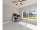 Bright office featuring tile flooring, a ceiling fan, and a large window overlooking the lawn at 2723 Jollivette Rd, North Port, FL 34288
