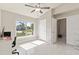 Bright and airy bedroom featuring tile flooring, a ceiling fan, and a large window overlooking the lawn at 2723 Jollivette Rd, North Port, FL 34288