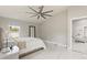 Bright bedroom with tile floors, a cozy bed, and a view to the outside at 2723 Jollivette Rd, North Port, FL 34288