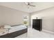 Neutral bedroom with a twin bed, dark wood dresser, and bright natural light at 2723 Jollivette Rd, North Port, FL 34288