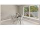 Breakfast nook features a glass table and four chairs near a big window at 2723 Jollivette Rd, North Port, FL 34288