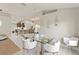 The dining room features a glass table, white chairs, modern lighting, and an open floor plan at 2723 Jollivette Rd, North Port, FL 34288
