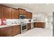 Charming kitchen with modern appliances and wood cabinets overlooking a living area at 2723 Jollivette Rd, North Port, FL 34288