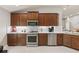 This is a bright kitchen with modern appliances, wood cabinets and quartz counters at 2723 Jollivette Rd, North Port, FL 34288