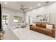 Open-concept living room featuring neutral walls and a brown leather couch at 2723 Jollivette Rd, North Port, FL 34288