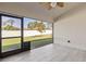 Screened patio with ceiling fan overlooks the backyard and has a tile floor, providing an outdoor living space at 2723 Jollivette Rd, North Port, FL 34288