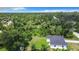 An aerial view of a single-story home surrounded by dense trees at 17041 Malta Ave, Port Charlotte, FL 33954