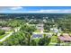 An aerial view of a neighborhood featuring single-story homes and many trees at 17041 Malta Ave, Port Charlotte, FL 33954