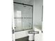 Bathroom with glass enclosed tub and shower, with modern fixtures at 17041 Malta Ave, Port Charlotte, FL 33954