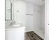 Bathroom with double vanity, framed mirrors, and tiled shower at 17041 Malta Ave, Port Charlotte, FL 33954
