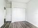 Bedroom featuring a closet with paneled doors and wood-look floors at 17041 Malta Ave, Port Charlotte, FL 33954
