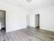 Bedroom featuring wood-look floors and access to the bathroom and closet at 17041 Malta Ave, Port Charlotte, FL 33954