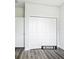 Bedroom with closet featuring bi-fold doors, neutral walls and gray floors at 17041 Malta Ave, Port Charlotte, FL 33954