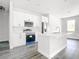 Bright kitchen features white cabinets, stainless steel appliances, and a center island with a sink at 17041 Malta Ave, Port Charlotte, FL 33954