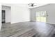 Spacious living room with sleek floors, a ceiling fan, and sliding glass doors to the backyard at 17041 Malta Ave, Port Charlotte, FL 33954