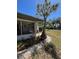 Charming home featuring a lush backyard with mature landscaping and a screened patio at 355 Highland Shores Dr, Ellenton, FL 34222