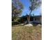 Spacious backyard with a screened porch and lush landscaping, ideal for outdoor living at 355 Highland Shores Dr, Ellenton, FL 34222