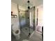 Bathroom featuring tiled shower with frameless glass doors, a modern toilet, and contemporary fixtures at 355 Highland Shores Dr, Ellenton, FL 34222