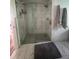 This bathroom boasts marble tiling, a glass shower enclosure, and neutral-toned decor at 355 Highland Shores Dr, Ellenton, FL 34222