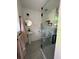 Bathroom featuring pedestal sink, round mirror, modern toilet, and tiled shower with frameless glass doors at 355 Highland Shores Dr, Ellenton, FL 34222