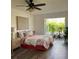 Bright bedroom with patio access, ceiling fan, hardwood floors, and tasteful furnishings at 355 Highland Shores Dr, Ellenton, FL 34222