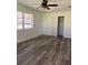 This is a bright bedroom featuring wood-look floors, ceiling fan, and a window with blinds at 355 Highland Shores Dr, Ellenton, FL 34222