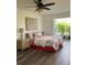 Cozy bedroom with a ceiling fan, hardwood floors, patio view, and stylish decor at 355 Highland Shores Dr, Ellenton, FL 34222