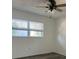 This bedroom features wood-look floors, a ceiling fan, and a window with blinds at 355 Highland Shores Dr, Ellenton, FL 34222