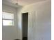 Bright bedroom with wood-look floors, a closet, and a window with mini blinds at 355 Highland Shores Dr, Ellenton, FL 34222