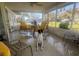Bright screened porch with comfortable seating, perfect for enjoying outdoor views at 355 Highland Shores Dr, Ellenton, FL 34222