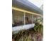 Covered screened porch with seating and views of the home's backyard and landscaping at 355 Highland Shores Dr, Ellenton, FL 34222