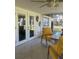Inviting screened porch with comfortable yellow seating, perfect for relaxing and enjoying outdoors at 355 Highland Shores Dr, Ellenton, FL 34222