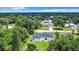 An aerial view of the home and yard showing beautiful landscaping with lush mature trees at 23113 Brewer Ave, Punta Gorda, FL 33980