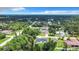 An aerial view of the home and yard showing beautiful landscaping with lush mature trees at 23113 Brewer Ave, Punta Gorda, FL 33980