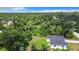 An aerial view of the home and yard showing beautiful landscaping with lush mature trees at 23113 Brewer Ave, Punta Gorda, FL 33980
